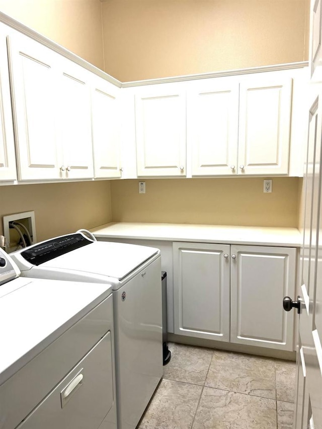 laundry room featuring cabinet space and washing machine and dryer