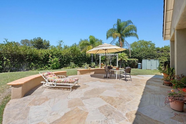 view of patio with outdoor dining space and fence