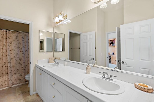 full bath featuring tile patterned floors, a sink, toilet, and double vanity