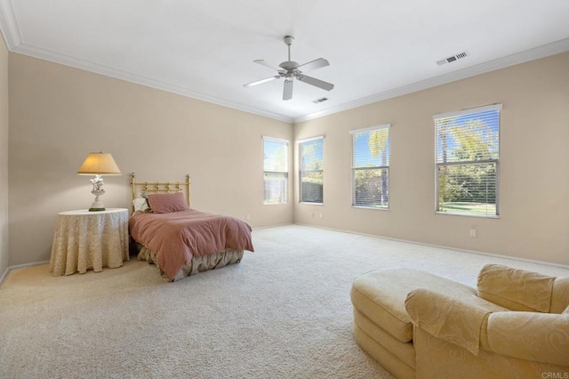 carpeted bedroom featuring ornamental molding, visible vents, baseboards, and a ceiling fan