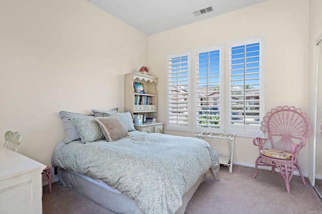 bedroom with light carpet, visible vents, and baseboards