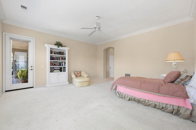 bedroom with carpet floors, arched walkways, visible vents, and crown molding