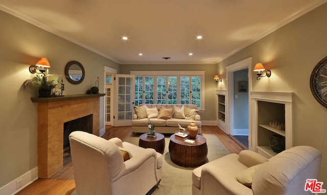 living room featuring light hardwood / wood-style floors and ornamental molding