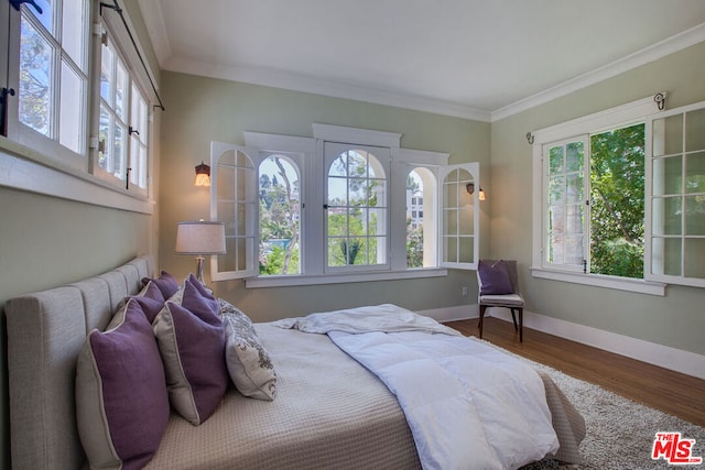 bedroom featuring crown molding and hardwood / wood-style floors