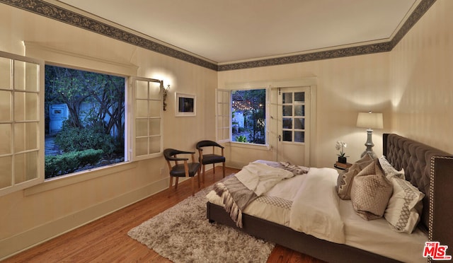 bedroom featuring hardwood / wood-style flooring and ornamental molding