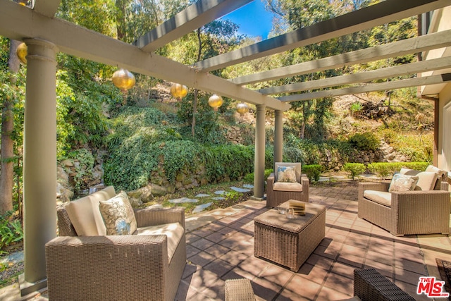 view of patio featuring an outdoor living space and a pergola