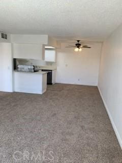 unfurnished living room featuring ceiling fan and carpet flooring