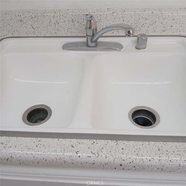 room details featuring sink and white cabinets