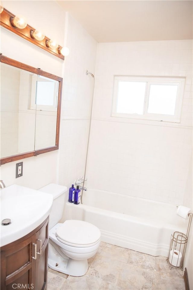 full bathroom featuring tiled shower / bath combo, vanity, toilet, and a healthy amount of sunlight