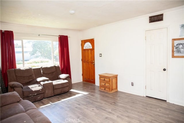 living room with hardwood / wood-style flooring and ornamental molding