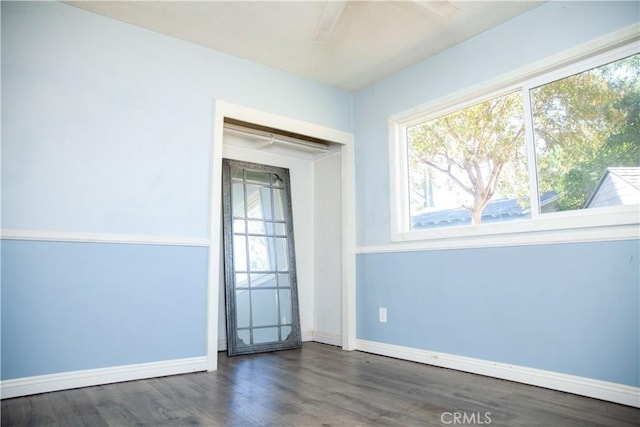 unfurnished room with dark hardwood / wood-style floors