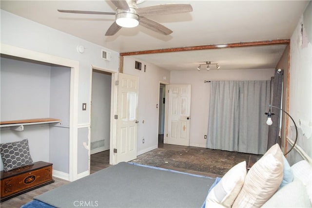 bedroom featuring dark hardwood / wood-style flooring, ceiling fan, and a closet