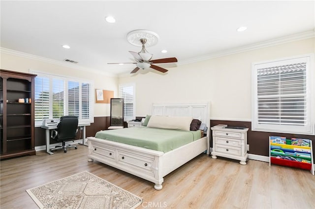 bedroom featuring ceiling fan, light hardwood / wood-style flooring, and ornamental molding