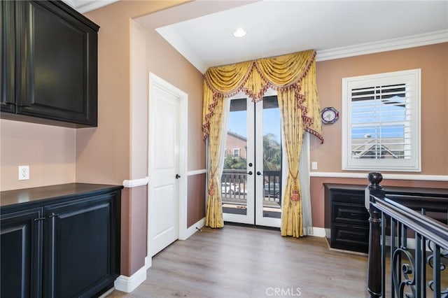 doorway to outside featuring crown molding, french doors, and light hardwood / wood-style floors