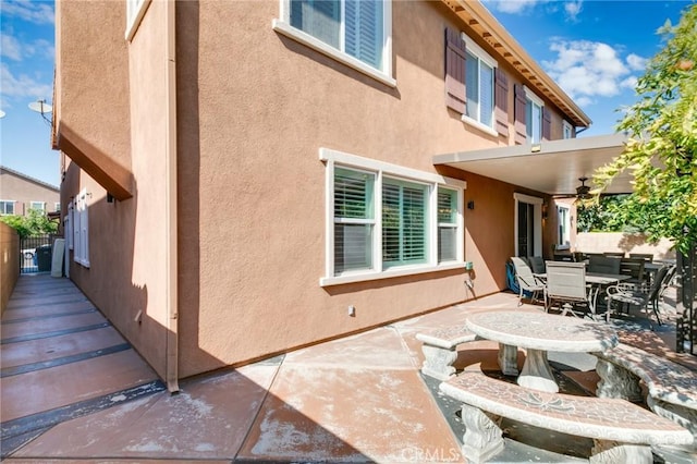 back of house with a patio and ceiling fan