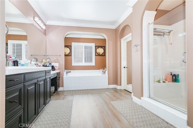 bathroom with separate shower and tub, hardwood / wood-style floors, vanity, and ornamental molding