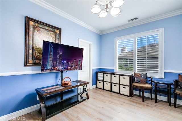 interior space featuring light hardwood / wood-style floors, crown molding, and a chandelier