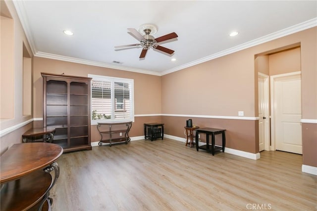 interior space with ceiling fan, ornamental molding, and light hardwood / wood-style flooring