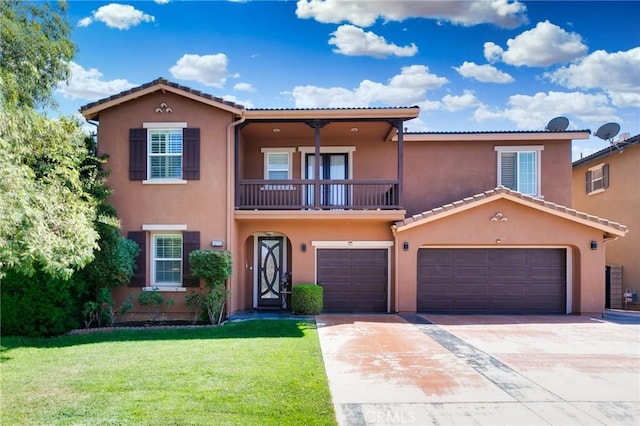 mediterranean / spanish home with a garage, a balcony, and a front yard