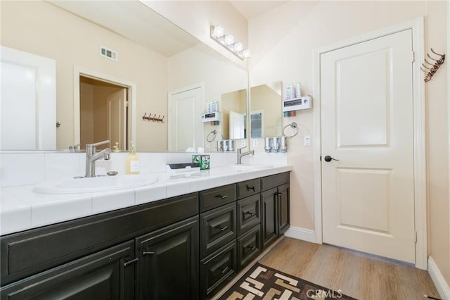 bathroom with vanity and hardwood / wood-style flooring