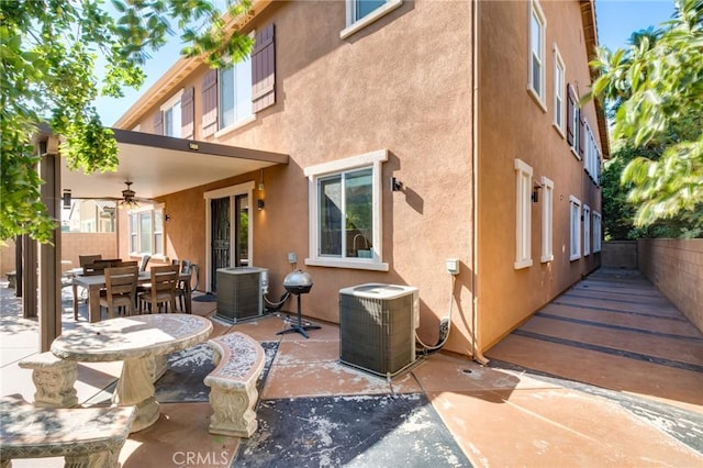 rear view of property with a patio, central AC unit, and ceiling fan