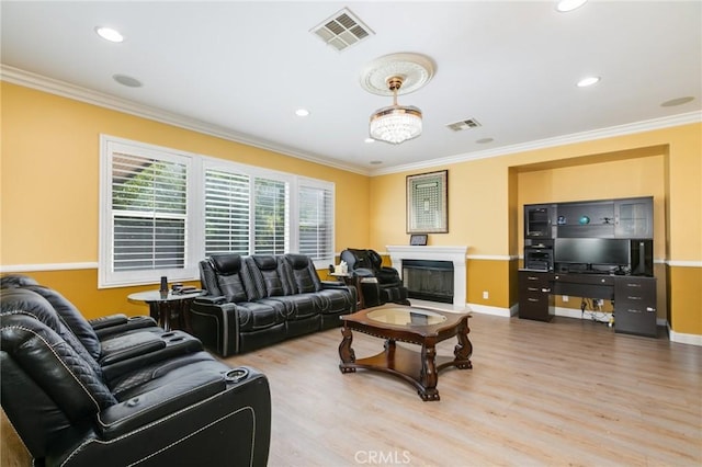 living room featuring wood-type flooring and ornamental molding