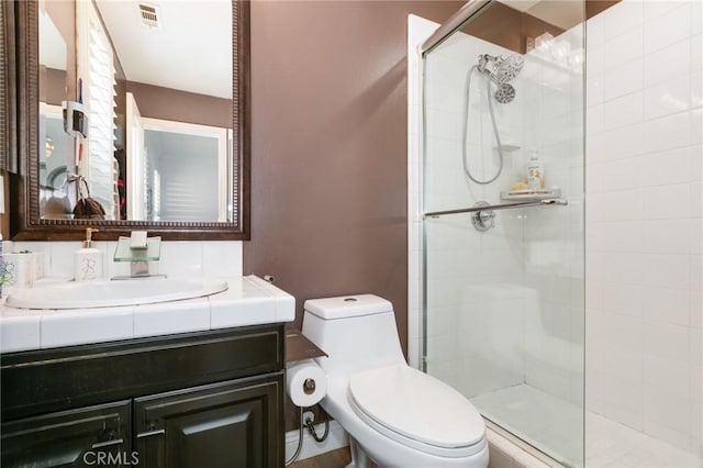 bathroom with vanity, an enclosed shower, and toilet