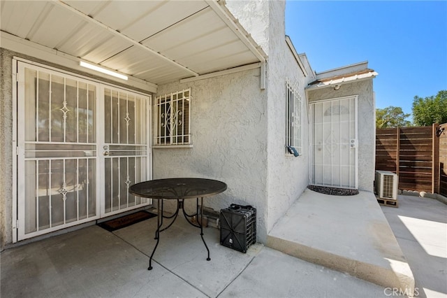 view of exterior entry with a patio