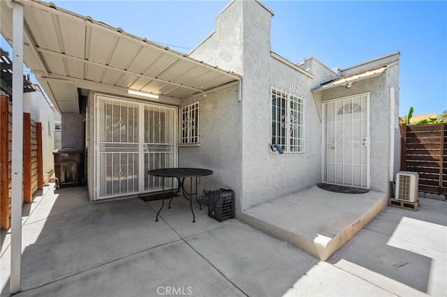 view of exterior entry with a patio