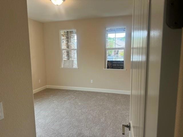 empty room featuring light carpet