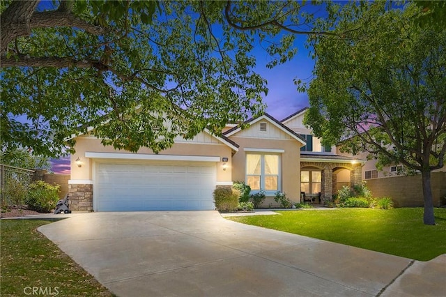 view of front of home featuring a lawn and a garage