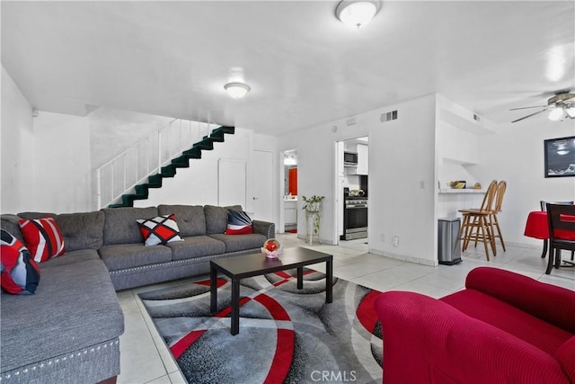 living room with light tile patterned floors and ceiling fan