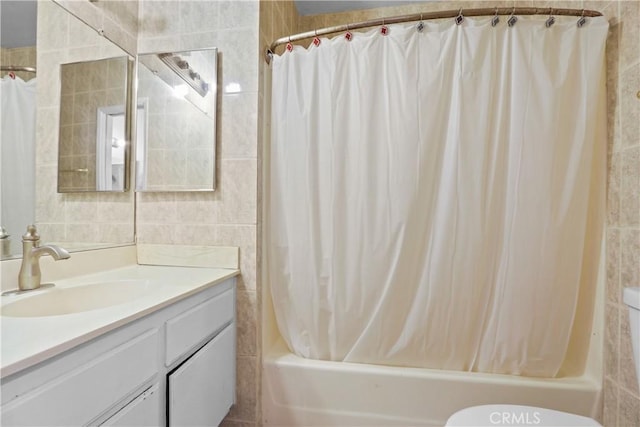 full bathroom with shower / bath combo, vanity, toilet, and tile walls