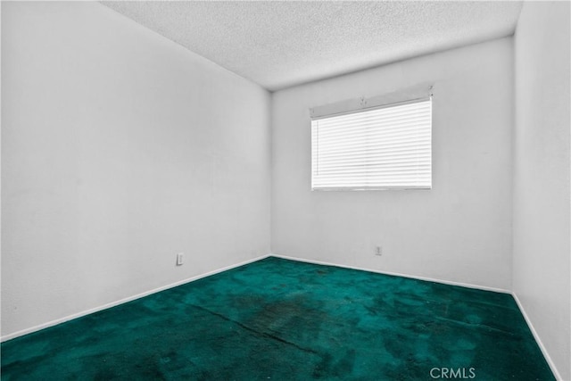 empty room featuring carpet and a textured ceiling