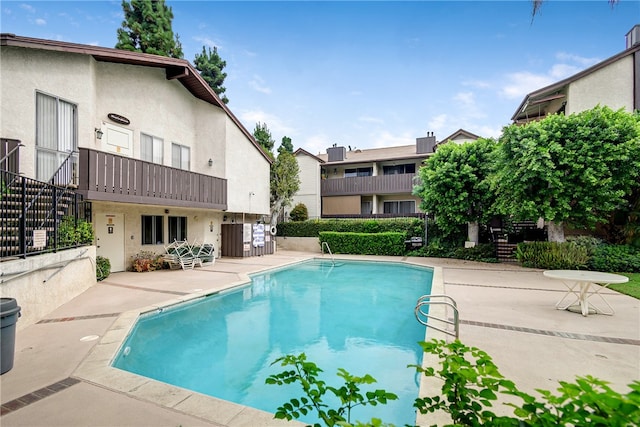 view of swimming pool with a patio area