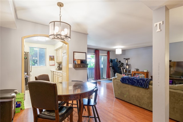 dining space featuring an inviting chandelier and light hardwood / wood-style flooring