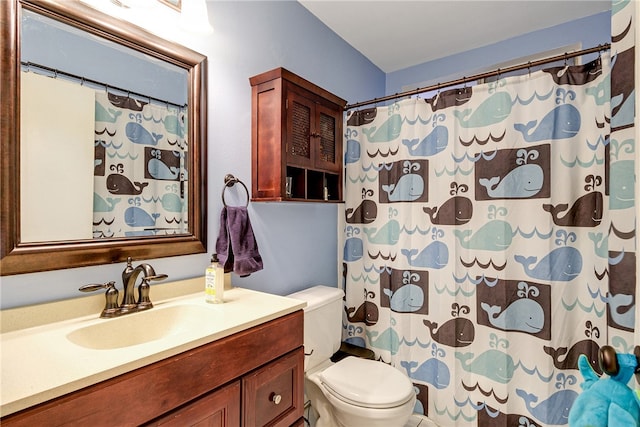 bathroom featuring vanity, toilet, and curtained shower