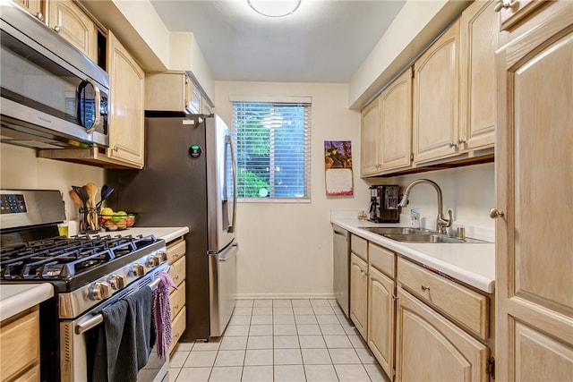 kitchen featuring light brown cabinets, appliances with stainless steel finishes, sink, and light tile patterned floors