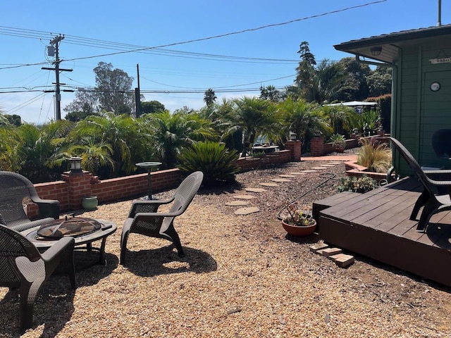 view of yard with a fire pit and a deck