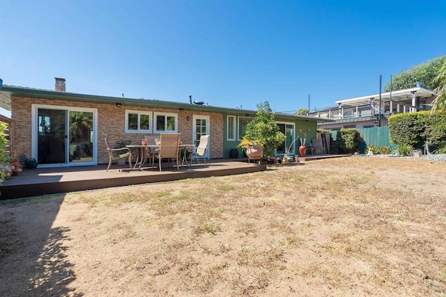 rear view of house featuring a wooden deck