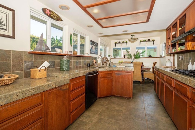 kitchen featuring stainless steel gas stovetop, dishwasher, and tasteful backsplash