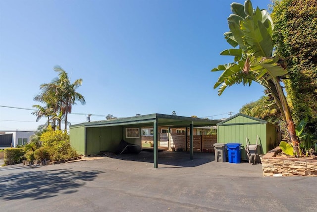 exterior space featuring a storage shed and a carport