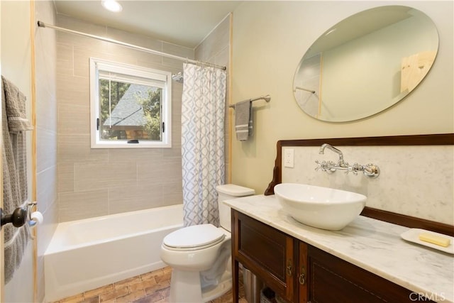 full bathroom featuring vanity, toilet, and shower / bathtub combination with curtain