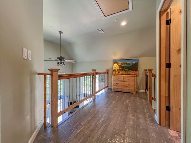 hallway with dark hardwood / wood-style floors and lofted ceiling