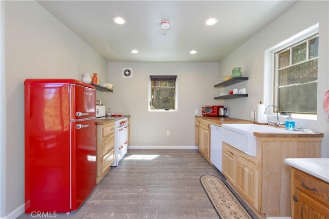 kitchen featuring sink, white appliances, dark wood-type flooring, and light brown cabinetry