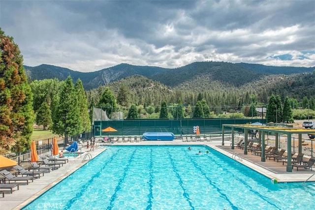 view of pool with a mountain view and a patio