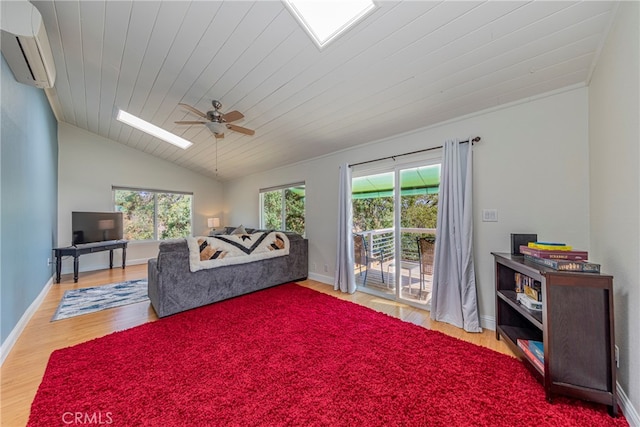 living room featuring light hardwood / wood-style floors, ceiling fan, a wall mounted air conditioner, and plenty of natural light