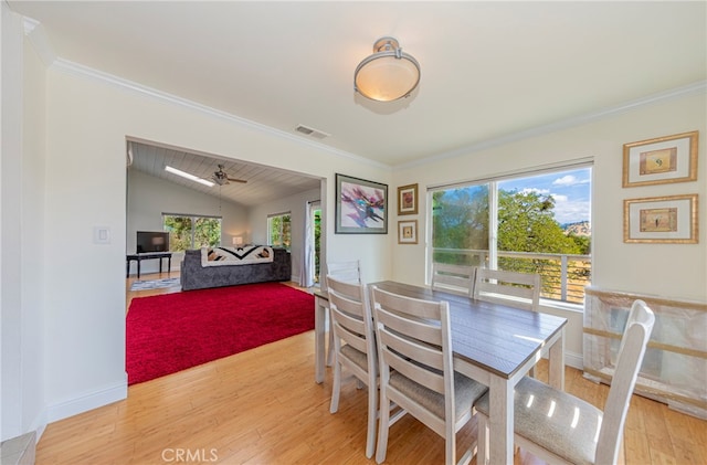 dining space with ceiling fan, light hardwood / wood-style flooring, ornamental molding, and lofted ceiling