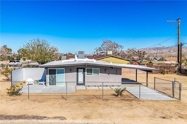 view of front of property featuring a carport and central air condition unit