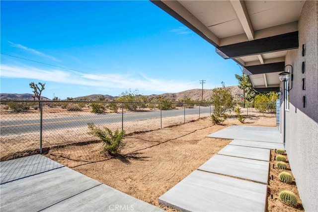 view of yard with a mountain view and a patio area